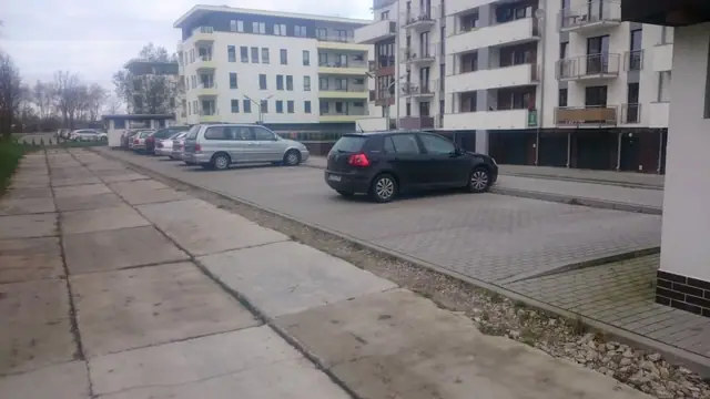 Stara nawierzchnia z płyt betonowych przy nowych blokach mieszkalnych na ulicy Wielkopolskiej w Kołobrzegu